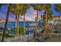 Stunning sunset view over the marina, boats, and palm trees at 363 Pinellas Bayway S # 33, Tierra Verde, FL 33715