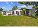 Single story home with a two car garage and well maintained lawn at 6243 Seaford Dr, Holiday, FL 34690