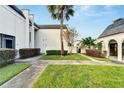 Exterior view of condo building showcasing manicured lawn and walkway at 716 Oakgrove Dr # 240, Brandon, FL 33510