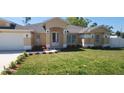 Inviting single-story home with fresh landscaping and a well-manicured front lawn at 103 2Nd Ne Ave, Lutz, FL 33549