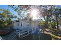 House exterior with a white ramp and mature trees in the front at 1708 Preston S St, St Petersburg, FL 33712