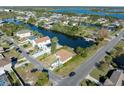 Aerial view of a house located on a canal, with a camper, and surrounded by other houses at 3306 Holly Springs Dr, Hernando Beach, FL 34607