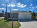 Newly built home with modern exterior, attached garage, and a spacious front yard at 5714 Olive Dr, New Port Richey, FL 34652
