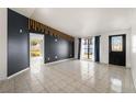 Bright living room with tiled floors and dark accent wall at 9102 Post Oak Ct, Tampa, FL 33615