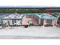 Aerial view of beachfront condo building with pool and beach access at 18400 Gulf Blvd # 1302, Indian Shores, FL 33785