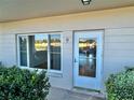 Condo unit entry with a white door and windows at 2284 Philippine Dr # 9, Clearwater, FL 33763
