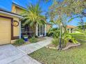 Landscaped front yard with palm trees and a walkway to the house at 2915 126Th E Ter, Parrish, FL 34219
