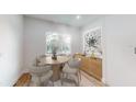 Small dining area with round wooden table and four light-beige chairs at 4675 Hickory Oak Dr, Brooksville, FL 34601