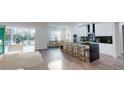 Modern kitchen with island, stainless steel appliances, and breakfast bar at 4675 Hickory Oak Dr, Brooksville, FL 34601