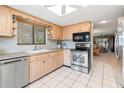 Bright kitchen with stainless steel appliances and light wood cabinets at 8019 Feather Ct # C, Hudson, FL 34667