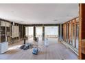 Under construction living room with new flooring and exposed framing at 17726 Long Point Dr, Redington Shores, FL 33708