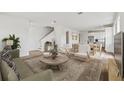 Open-concept living room with hardwood floors, modern decor, and ample natural light at 2021 Amelia Bay Pl, Valrico, FL 33596