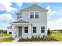 Two-story light gray home with landscaping at 2021 Amelia Bay Pl, Valrico, FL 33596