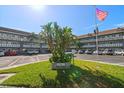 Building entrance with landscaping and a flag at 2447 Ecuadorian Way # 11, Clearwater, FL 33763