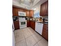 Bright kitchen with wood cabinets and granite countertops at 4660 Marine Pkwy # 202, New Port Richey, FL 34652