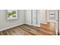 Bright bedroom featuring stylish wood floors and a window with natural light at 5825 S 5Th St, Tampa, FL 33611