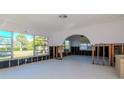 A living room under renovation with exposed framing and new windows at 603 Virginia Ave, Tarpon Springs, FL 34689