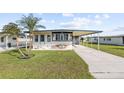 Single-Gathering home with carport and landscaped yard at 35209 Ada Ave, Zephyrhills, FL 33541