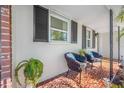 Inviting front porch with decorative chairs and terracotta tile flooring at 11211 60Th Ave, Seminole, FL 33772