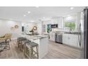 Bright, open kitchen with granite countertops, stainless appliances, and modern finishes at 11211 60Th Ave, Seminole, FL 33772