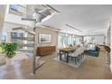 Open concept dining room featuring a modern spiral staircase and stylish furnishings with natural light at 2401 Bayshore Blvd # 410 & 510, Tampa, FL 33629