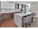 Modern kitchen with island, marble backsplash and hardwood floors at 301 1St S St # 2203, St Petersburg, FL 33701