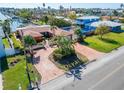 House with brick driveway and lush landscaping at 425 Capri Blvd, Treasure Island, FL 33706