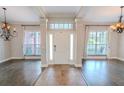 Bright and spacious entryway with hardwood floors and elegant light fixtures at 511 Crowned Eagle Ct, Valrico, FL 33594