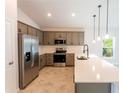 Modern kitchen with stainless steel appliances and white countertops at 133 Angol St, Punta Gorda, FL 33983