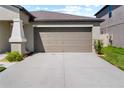 Two-car garage with neutral-toned door at 15410 Miller Creek Dr, Ruskin, FL 33573