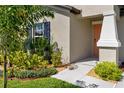 Side view showcasing landscaping and a neutral exterior at 15410 Miller Creek Dr, Ruskin, FL 33573