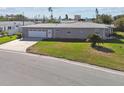 Ranch style home with attached garage and well-manicured lawn at 195 112Th Ave, Treasure Island, FL 33706