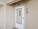 Condo building's front entrance with a white door at 2231 Utopian E Dr # 321, Clearwater, FL 33763