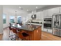 Bright kitchen features a large island with seating, stainless steel appliances, and white cabinetry at 33975 Astoria Cir, Wesley Chapel, FL 33545