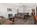 Inviting living room with modern flooring, ceiling fan, and comfortable furnishings at 7075 Lafayette N, Pinellas Park, FL 33781