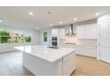 Bright, modern kitchen featuring a large island, stainless steel appliances, and white cabinets at 804 W Peninsular St, Tampa, FL 33603
