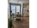 Dining area includes a four-person table and chairs, and a view of the kitchen at 919 50Th W Ave, Bradenton, FL 34207