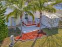 Elevated patio with a storage shed and tropical landscaping at 118 Saint Pierres Way, Apollo Beach, FL 33572