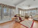 Living room with recliner, sofa, and wood-look flooring at 118 Saint Pierres Way, Apollo Beach, FL 33572