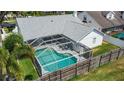 Enclosed screened pool area in backyard with lounge chairs at 15830 Glenarn Dr, Tampa, FL 33618