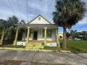 Charming 2-story home with a spacious front porch and mature palm trees at 2312 E 11Th Ave, Tampa, FL 33605