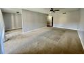 Spacious living room with carpeted floors and ceiling fan at 7639 Dolonita Dr # 7639, Tampa, FL 33615