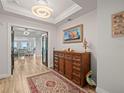 Elegant entryway with hardwood floors and statement furniture at 800 Collany Rd # 605 & 606, Tierra Verde, FL 33715