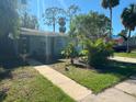 Cute light blue house with walkway, landscaping, and palm trees at 866 30Th S Ave, St Petersburg, FL 33705