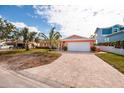 House exterior with a paved driveway and palm trees at 825 116Th Ave, Treasure Island, FL 33706