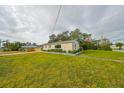 Side view of a renovated house showcasing its landscaping and curb appeal at 1161 Howard St, Clearwater, FL 33756