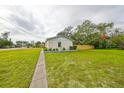 Backyard view of the house, highlighting a fence and side yard at 1161 Howard St, Clearwater, FL 33756