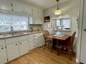 White kitchen with breakfast nook and pass-through window at 34185 Canal N Dr, Pinellas Park, FL 33781