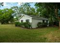 Classic home with a green lawn, and mature shrubs at 637 Jamaica Ave, Tampa, FL 33606