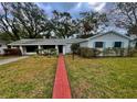 Traditional home with a brick walkway, green lawn, and neutral color scheme at 637 Jamaica Ave, Tampa, FL 33606